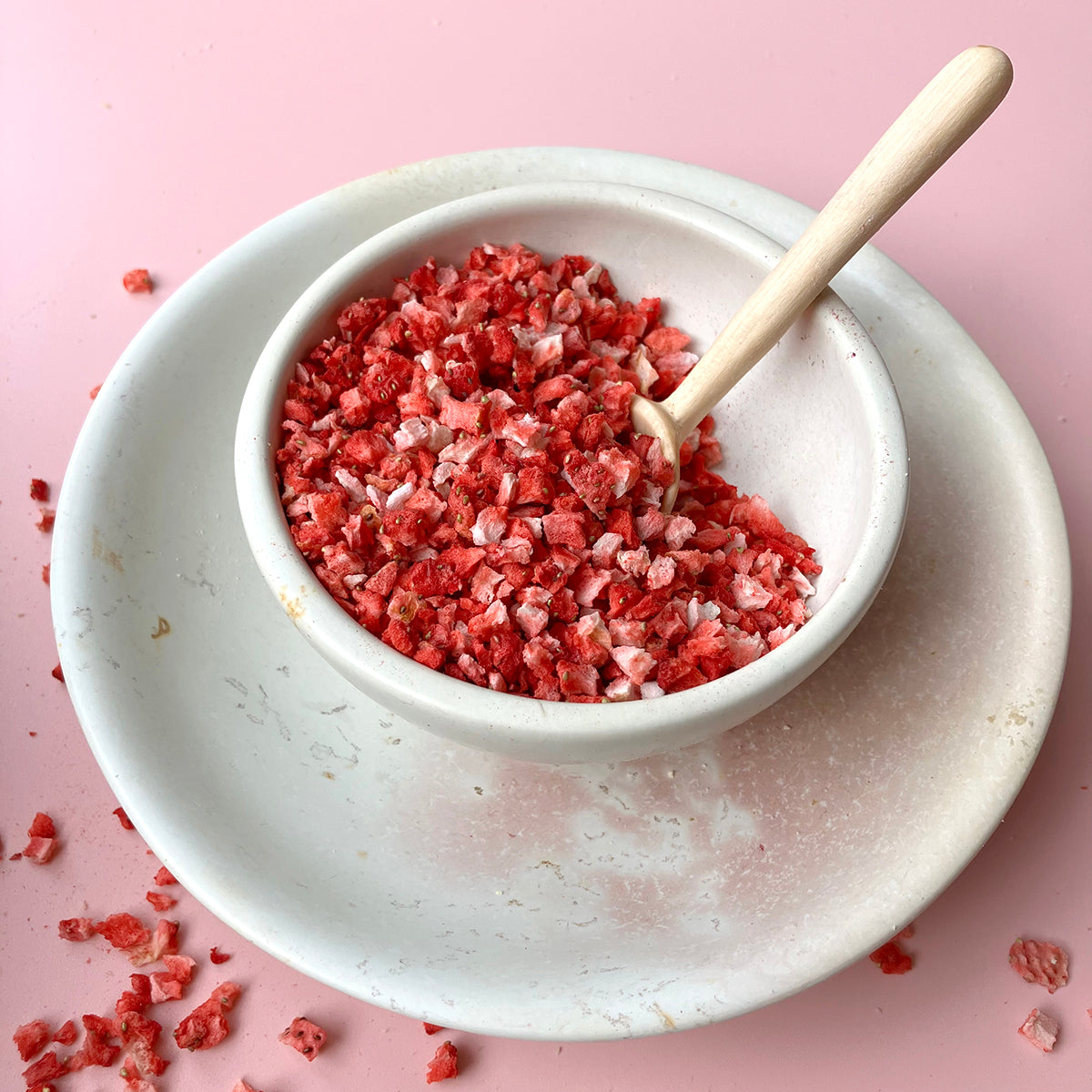 Freeze dried strawberry crumbs from Whole Food Earth, dried fruit snack with vibrant red strawberry pieces and crumbly texture.