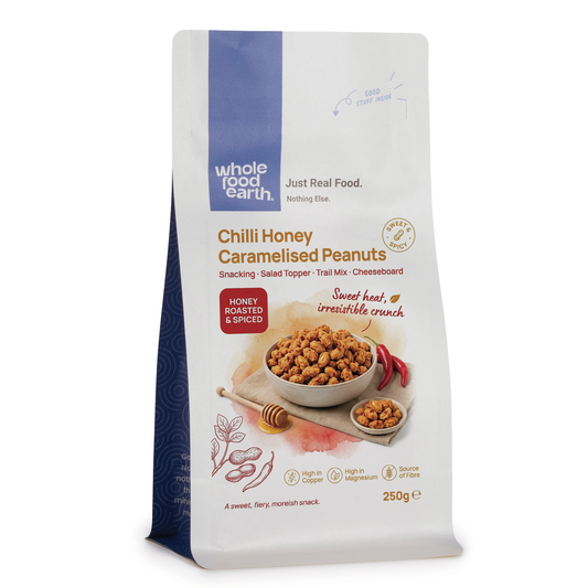Caramelized peanuts with chili and honey in a bowl, packaged by Whole Food Earth, highlighting nuts and seeds snack.