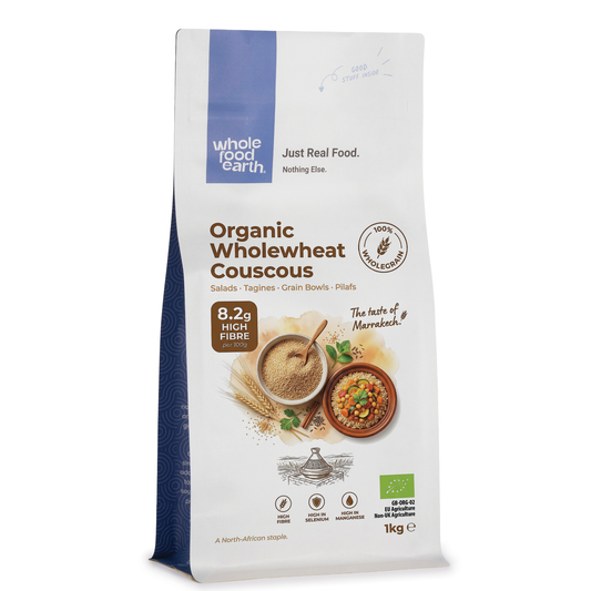 Whole Food Earth organic whole wheat couscous in a clear bowl, showcasing fluffy, light grains on a white background.