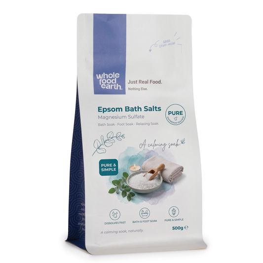 Epsom bath salts from Whole Food Earth, mineral and salt blend for relaxation, shown in a clear glass jar with a scoop.