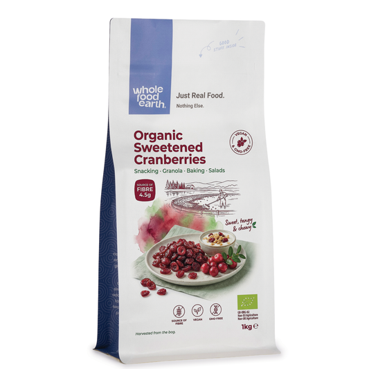 Organic sweetened dried cranberries by ArtisanBox, close-up of vibrant red, chewy dried berries in a clear container.
