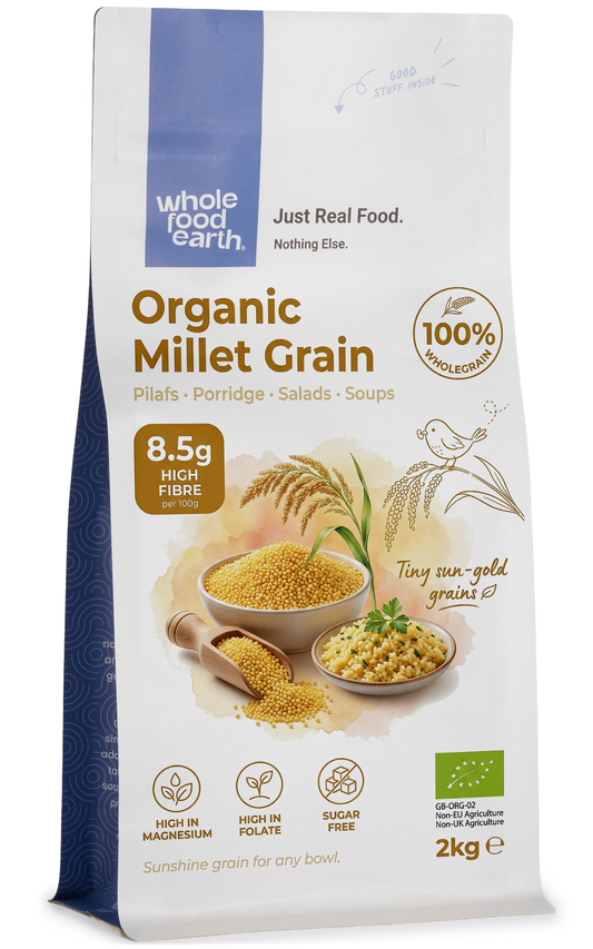 Organic millet grain from Whole Food Earth, showing small, round, golden millet seeds in a natural pile.