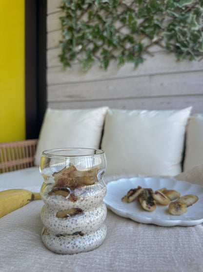 Creamy overnight oats in a glass jar topped with fresh fruit and nuts, prepared by Gurt Lush Food Co.