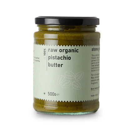 Creamy organic raw pistachio butter in a jar, made by Whole Food Earth, showcasing a smooth, natural nut butter texture.