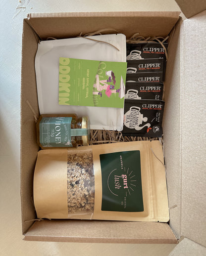 Gurt Lush Food Co Bristol breakfast hamper with assorted jams, bread, and breakfast treats in a wicker basket.