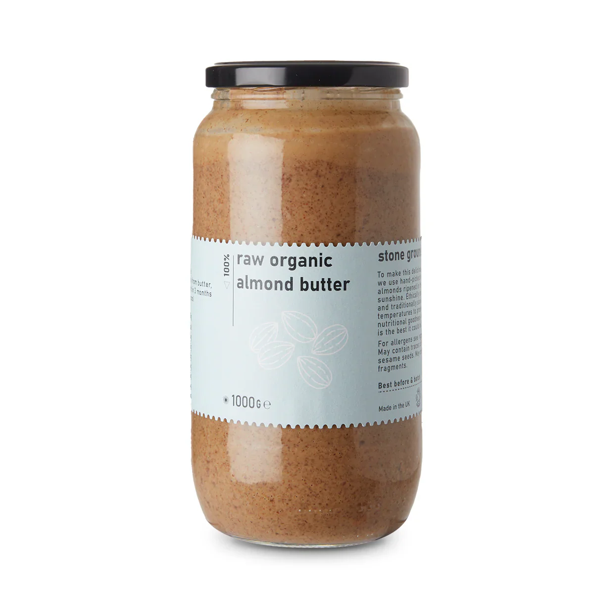 Creamy raw organic almond butter from Whole Food Earth, spread on a wooden spoon with a jar in the background.