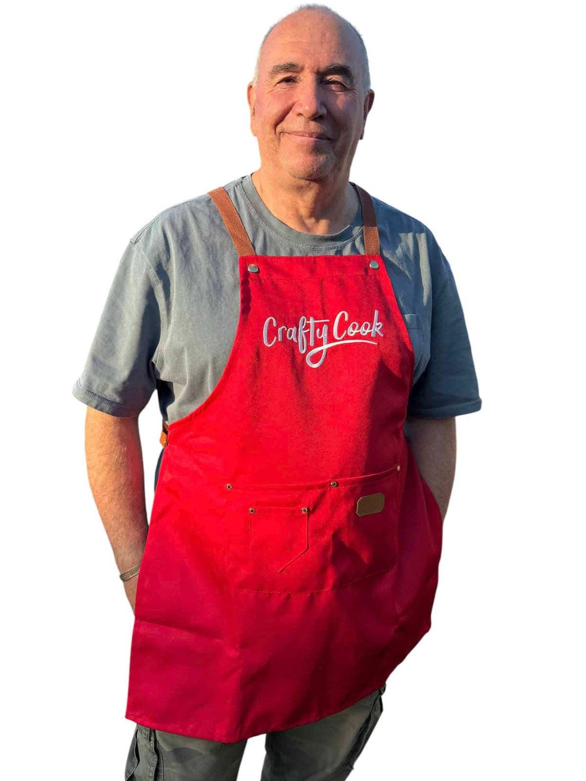 Red Crafty Cook apron with pockets, featuring a durable fabric and adjustable straps for cooking and baking activities.