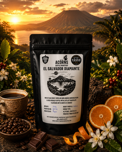 Medium roast coffee from El Salvador Diamante by Acorns Coffee & Cake featuring rich chocolate and orange flavors on volcanic scenery packaging.