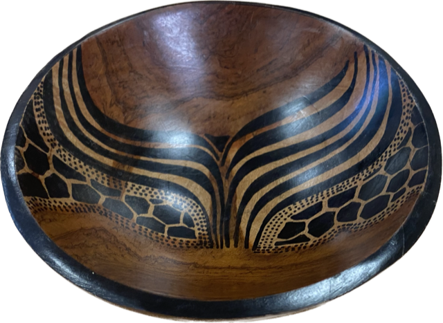 Hand-carved African wooden bowl by Goch & Co showcasing intricate traditional patterns and smooth polished surface.