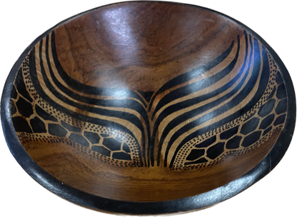 Hand-carved African wooden bowl by Goch & Co showcasing intricate traditional patterns and smooth polished surface.
