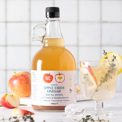 Whole Food Earth Kent Apple Cider Vinegar 4-pack with "Mother," raw, unpasteurized, unfiltered, GMO-free bottles on a kitchen countertop