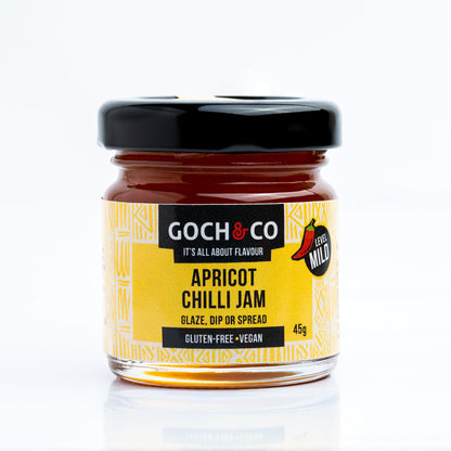 Jar of Goch & Co Apricot Chilli Jam with apricots and chili peppers visible, showcasing a vibrant, fruity and spicy condiment.