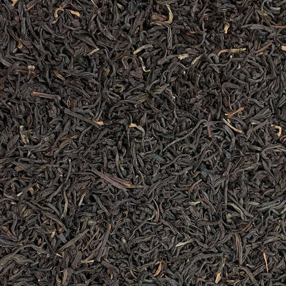 Loose leaf Assam Bukhial TGFOP tea from High Teas, showcasing golden tips and dark tea leaves in a fresh, aromatic blend.