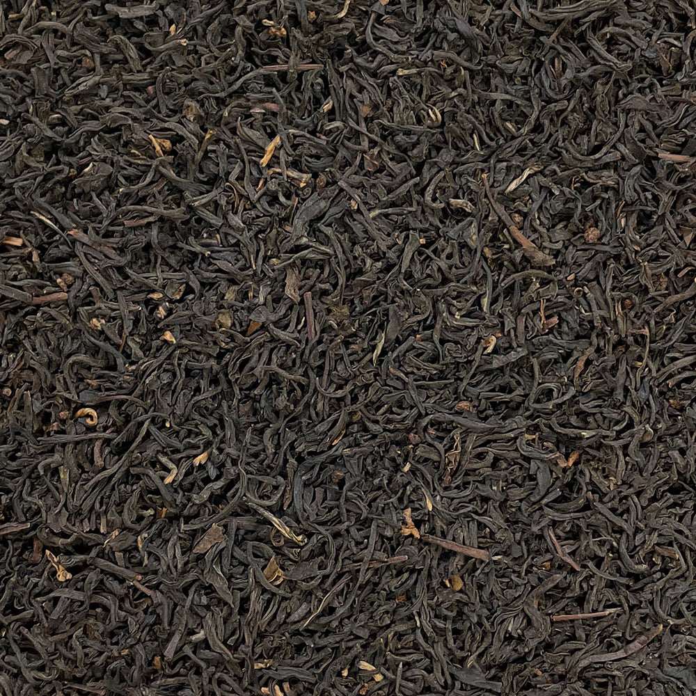 Assam Hunwal 2nd flush tea leaves from High Teas, showcasing fresh, whole tea leaves in a natural setting.