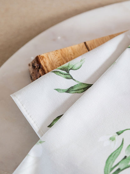 Snowdrop and hellebore floral tea towel from Avalon Home UK, showcasing spring botanical print and vibrant colors.
