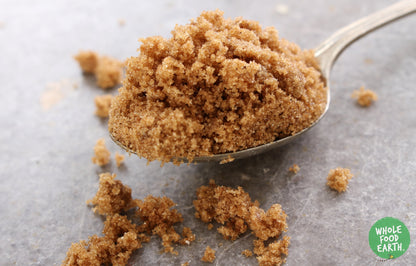 Whole Food Earth light Muscovado sugar in a jar, showing golden brown, moist sugar crystals from the Sugar & Sweeteners category.