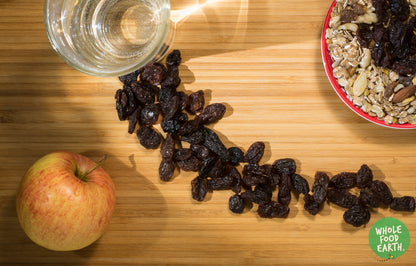 Jumbo black raisins from Whole Food Earth, dried fruits with large, dark, chewy raisins on a white background.