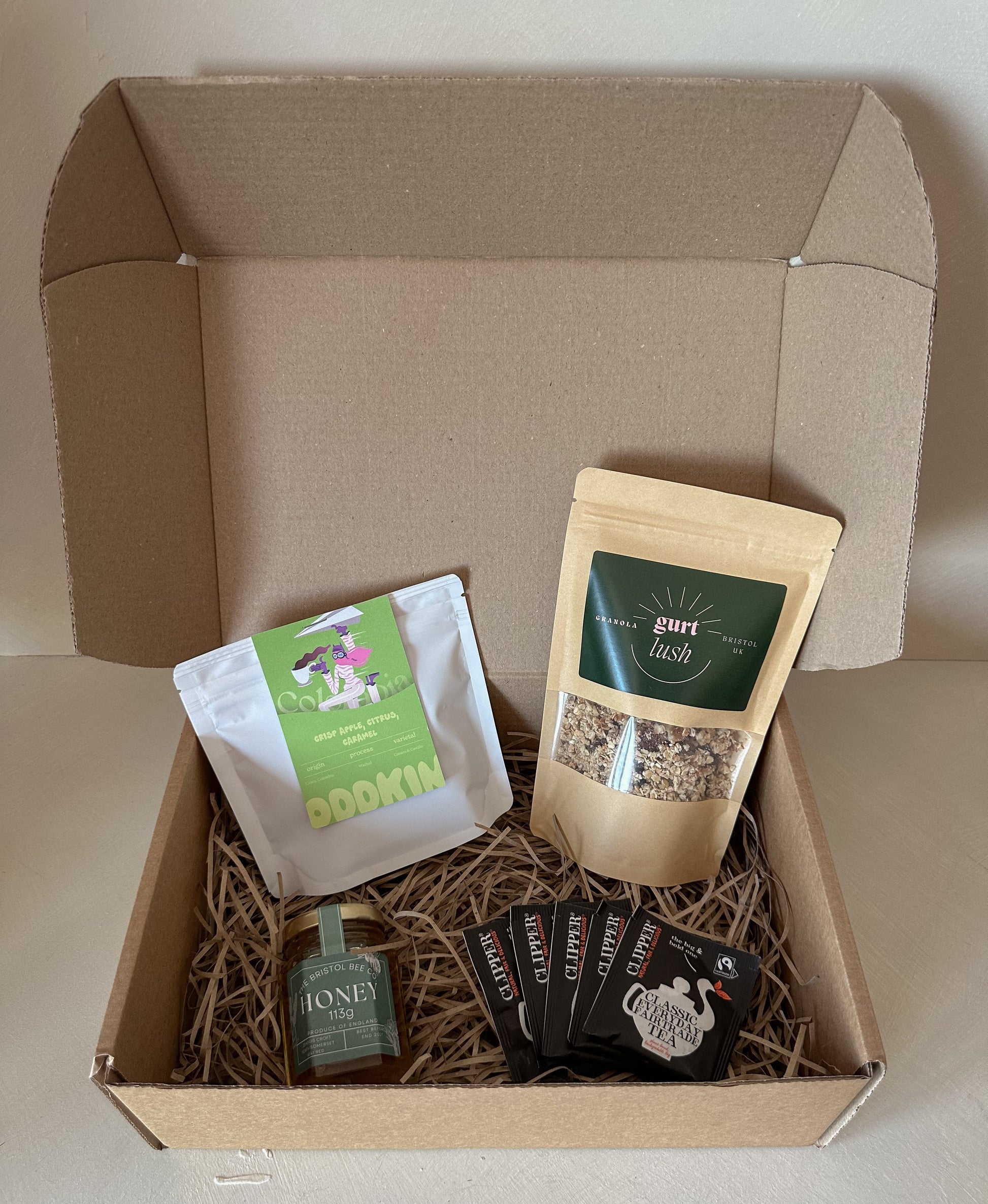 Bristol breakfast hamper from Gurt Lush Food Co featuring assorted breakfast items in a wicker basket.