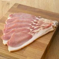 Smoked back bacon from Primrose Herd, dry cured, showing crispy, sliced bacon with smoky flavor and marbling.