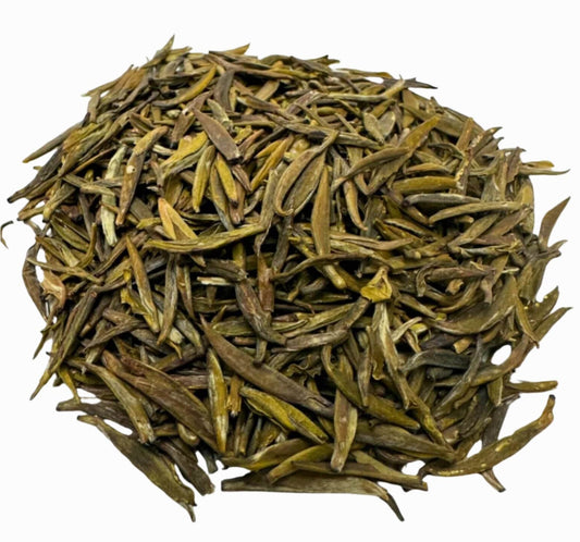 Porter Hill Tea Company's Badaling Yellow Tea, a green tea variety, displayed in a clear glass cup with tea leaves and brewed tea.