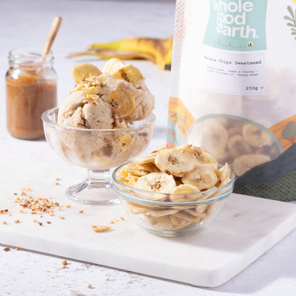 Sweetened banana chips by Whole Food Earth, dried fruit snack with crispy texture and golden color, suitable for healthy snacking.