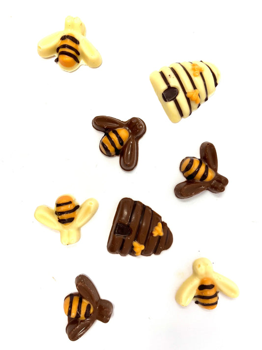 Close-up of bees on beehives with honeycomb, showcasing Gorvett & Stone bees and hive structures in a natural setting.