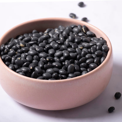 Whole Food Earth black beans in a bowl, fresh and cooked, showcasing the beans and their glossy black appearance.