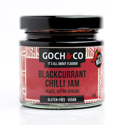 Jar of Goch & Co Blackcurrant Chilli Jam showing the label and vibrant dark purple jam with red chili pieces.