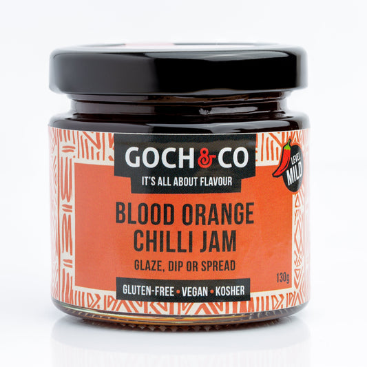 Jar of Goch & Co Blood Orange Chilli Jam showing vibrant orange jam with chili pieces and a label on the jar.
