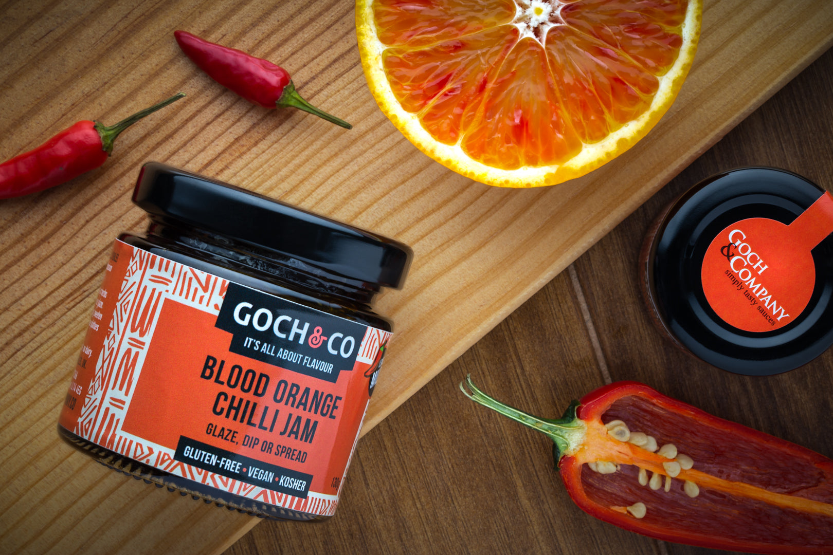 Bottle of Goch & Co Blood Orange Chilli Jam with vibrant orange and red hues, showcasing a spicy, citrus-flavored fruit spread.