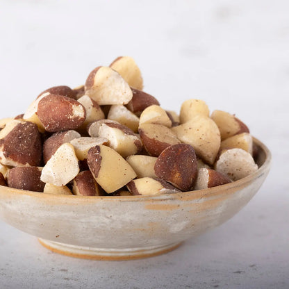 Broken Brazil nuts from Whole Food Earth display the cracked, natural nuts with rough shells and creamy interiors.