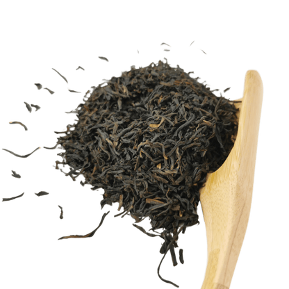 Loose leaf Bukhial Assam TGFOP black tea from Porter Hill Tea Company, showcasing dark, twisted tea leaves in a close-up shot.