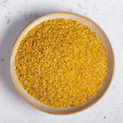 Whole Food Earth Bulgar Bulgur wheat in a bowl, showing the coarse grain texture of this natural, nutritious flour and grain product.