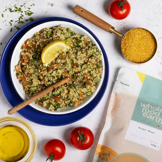 Organic bulgur wheat from ArtisanBox displayed in a kitchen setting with bowls and cooking ingredients.