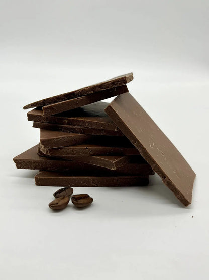 Handmade Cafe au Lait milk chocolate shards by Gorvett & Stone, showing irregular broken pieces with smooth, creamy texture.