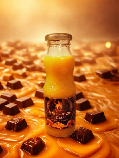 Creamy caramel popcorn mocha cold brew coffee from Ignite Coffee Co, served in a clear glass with whipped cream and caramel drizzle.