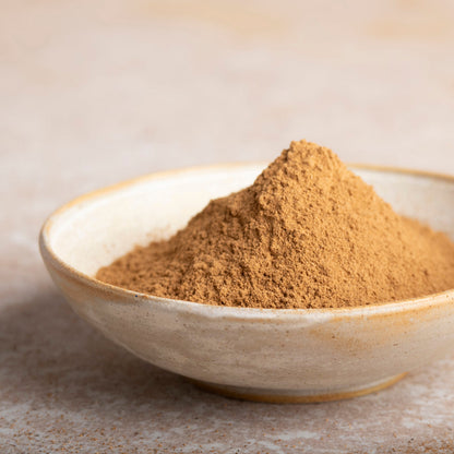 Ceylon cinnamon powder from Whole Food Earth, a fine, light brown spice in a clear container, used for baking and flavoring.