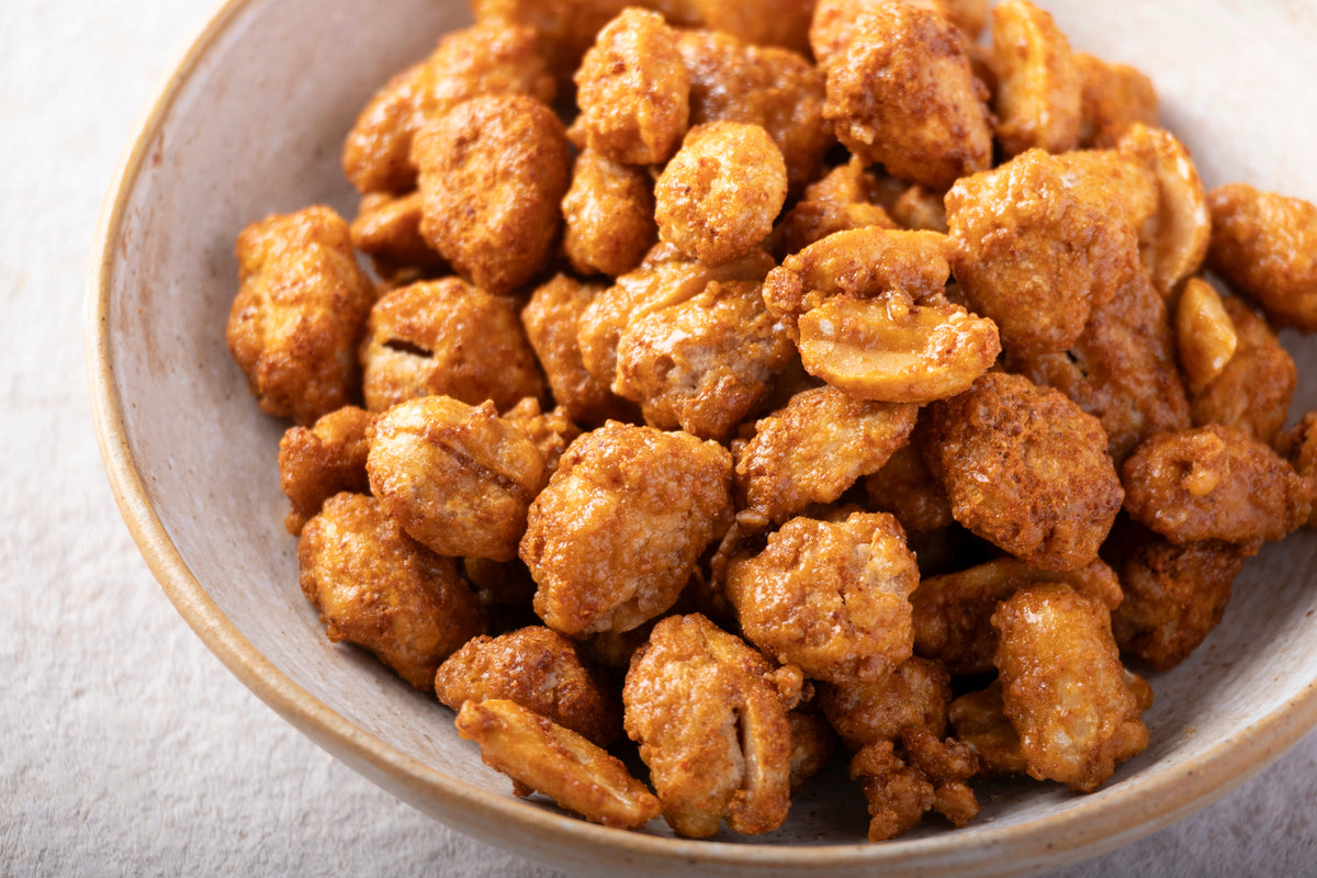 Sweet and spicy caramelized peanuts with chili and honey from Whole Food Earth, shown in a close-up image.