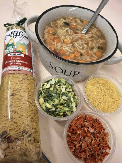 Crafty Cook Easy Meals FAMILY Plan Chinese chicken soup in a bowl with vegetables and herbs, ready to serve.