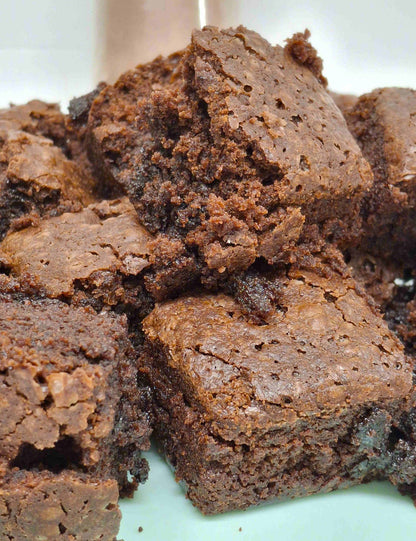 Gluten-free Christmas chocolate and orange brownie mix by Crafty Cook, with prepared brownies and orange slices on a baking tray.