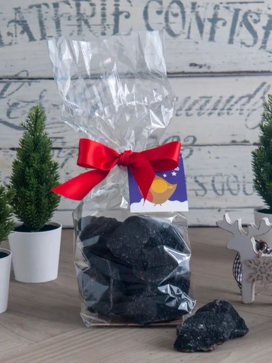 Limited edition Gorvett & Stone handmade Christmas coal made of cinder toffee and honeycomb, displayed in a festive setting.