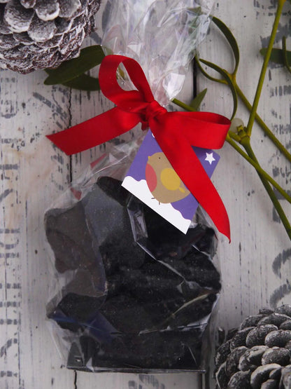 Limited edition handmade Christmas coal made of cinder toffee and honeycomb by Gorvett & Stone, packaged for the festive season.