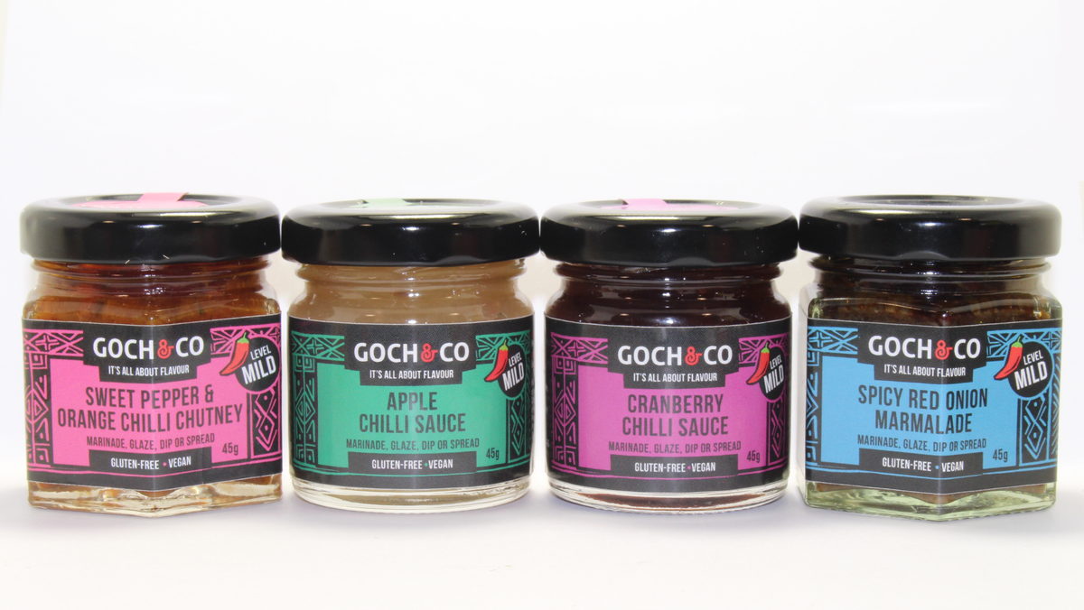 Assorted sweet and savory chili food items in a gift set from Goch & Co, displayed in festive packaging.