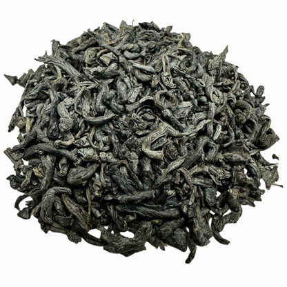 Porter Hill Tea Company Chunmee green tea leaves, dried and rolled, in a close-up image showcasing their texture and shape.
