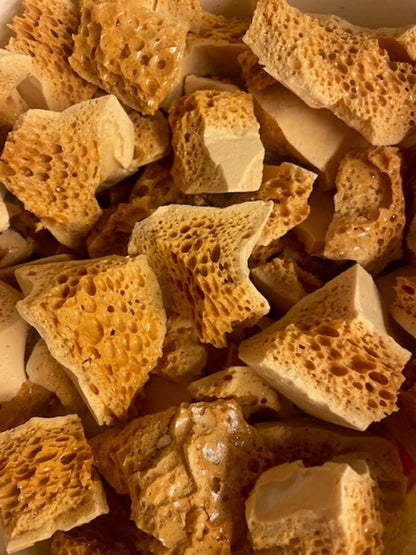 Handmade milk chocolate cinder toffee with honeycomb, showcasing golden, crunchy texture and caramelized toffee pieces.