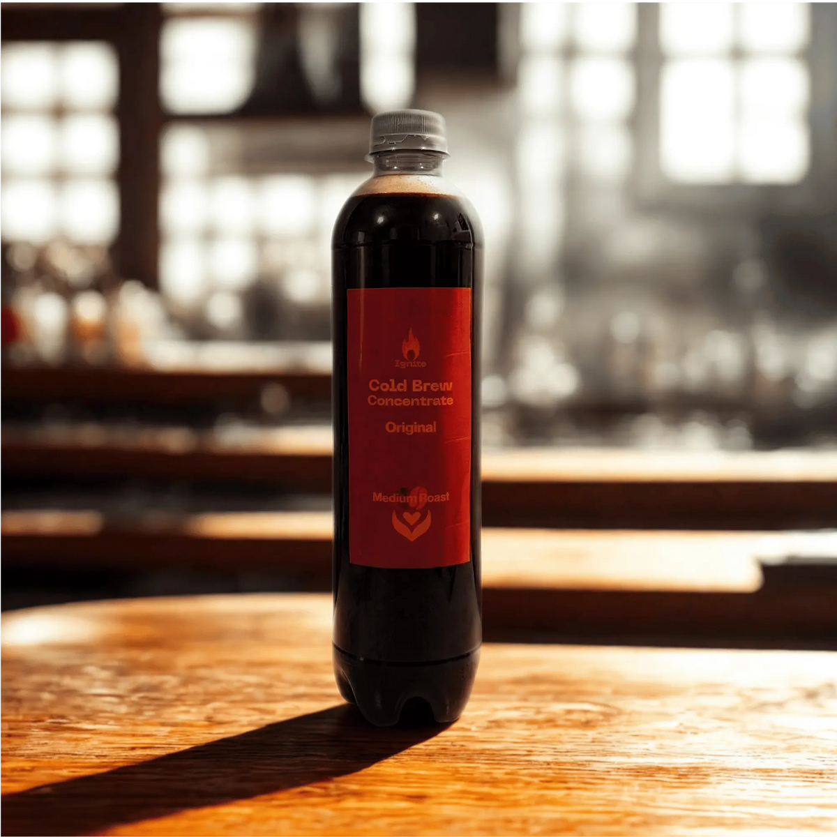 Original medium roast cold brew concentrate by Ignite Coffee Co, featuring a dark bottle and pour-over glass with ice.