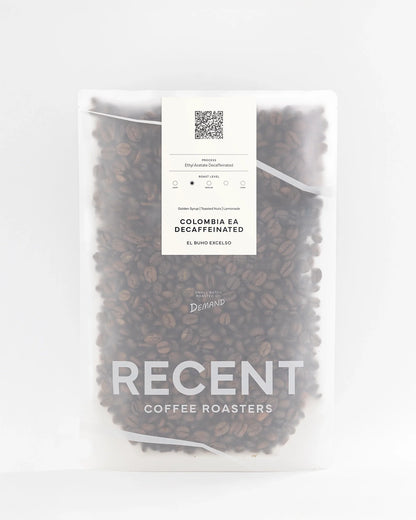 Decaf Colombia El Buho Excelso medium roast coffee beans from Recent Beans, showcasing fresh, roasted coffee in a bag.