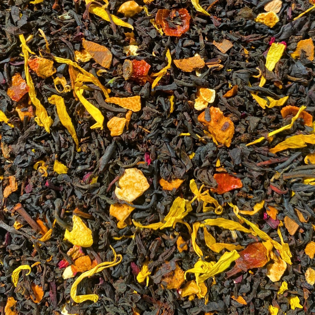 Black Pumpkin Spice Tea by Porter Hill Tea Company in a clear glass cup, showcasing the rich dark tea with pumpkin spice aroma.