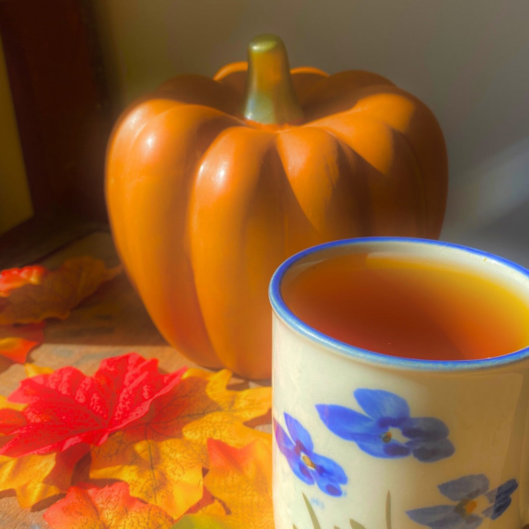 Black Pumpkin Spice Tea by Porter Hill Tea Company in a clear glass cup with a warm, aromatic brew.