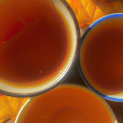 Black Pumpkin Spice tea from Porter Hill Tea Company with steaming hot brew in a cup on a cozy table.